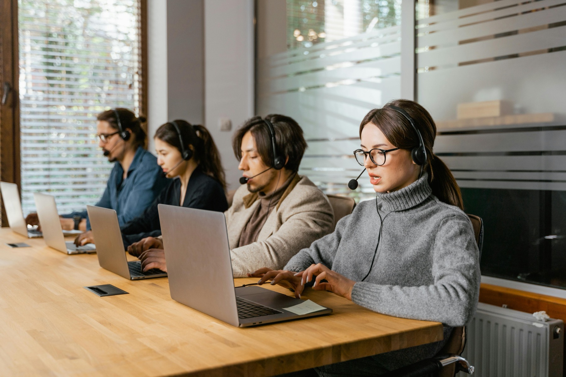 Commerce support team collaborating around laptops
